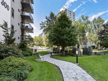 Exterior shot of winding pathway on green grass, at Prospect Place, NJ 07601 - Photo Gallery 4
