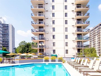 Luxury, resort-style pool with poolside chairs at Prospect Place, NJ 07601 - Photo Gallery 5