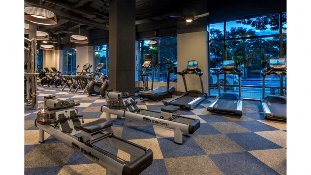 a gym with cardio equipment and a view of the pool  at Shearwood Station, New Rochelle, NY, 10801
