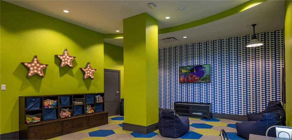 a living room filled with furniture and a flat screen tv  at Shearwood Station, New Rochelle