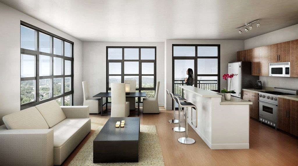 a woman standing in a living room next to a kitchen  at The Sheffield Englewood, Englewood, 07631