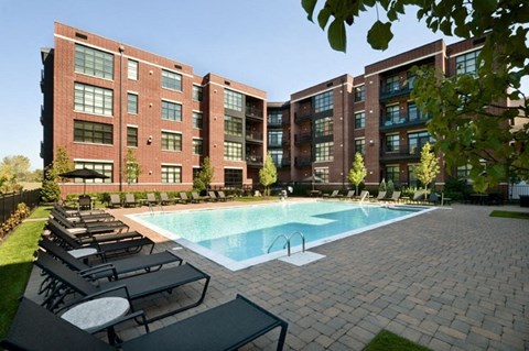 Swimming pool and lounge area at the Sheffield at Englewood Apartments in Englewood, NJ