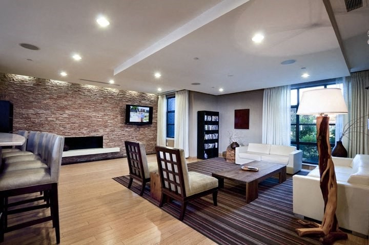 a living room filled with furniture and a flat screen tv  at The Sheffield Englewood, Englewood
