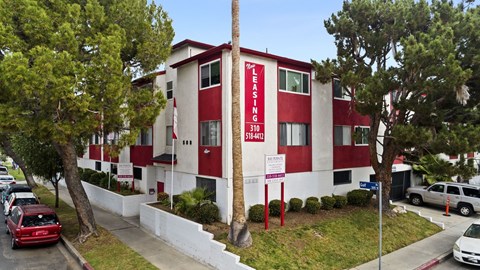A red and white building with the words "LEASING" and "310" on it.