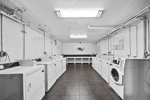 A laundry room with washers and dryers.