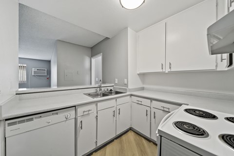A white kitchen with a stove top oven.