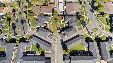 A bird's eye view of a residential neighborhood with houses and streets.
