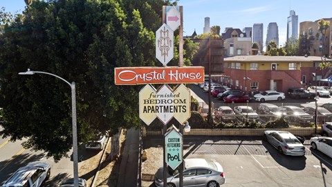 Crystal House furnished bedroom apartments sign.