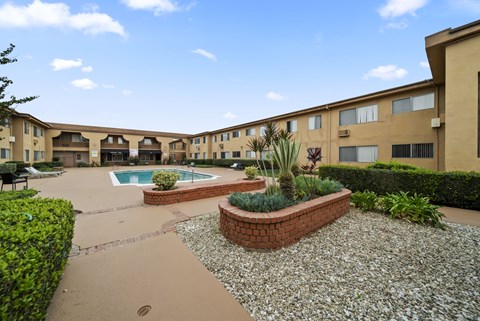 A courtyard with a pool and a small garden.