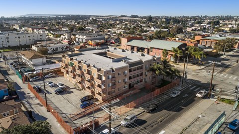 A view of a city from a high vantage point with buildings, cars, and a clear sky.