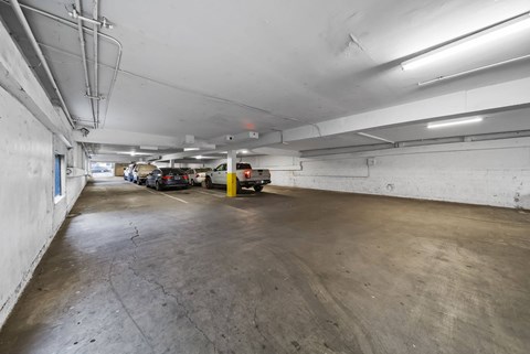 A parking garage with a concrete floor and white walls.