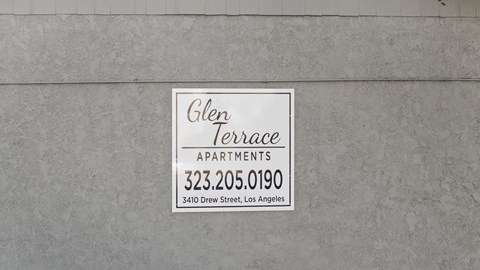 A sign for Glen Terrace Apartments is on a wall.