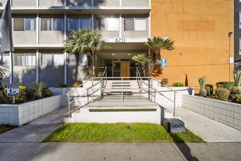The image shows the front of a building with the number 6711 on it.