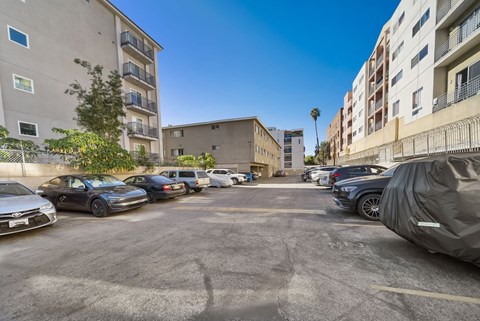 A parking lot with cars and buildings in the background.