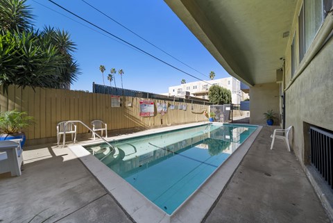 A small pool with a concrete floor and a concrete wall.