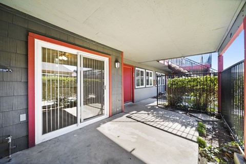 A red door with a glass window is on the left side of the image.