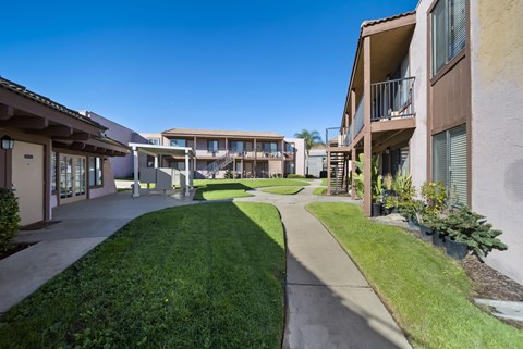 A sunny day at a residential complex with a clear blue sky.