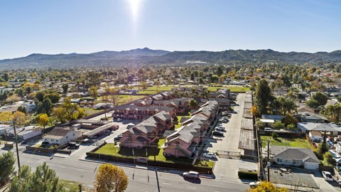 A sunny day in a residential area with houses and trees.
