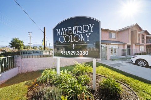 A sign for Mayberry Colony with a phone number on it.