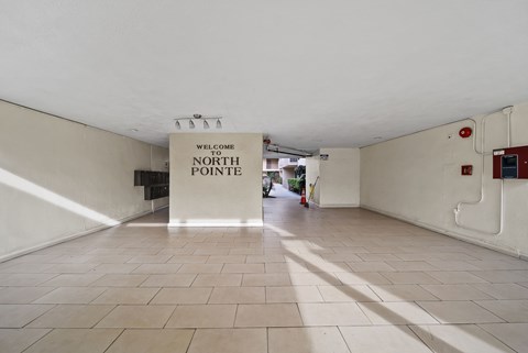 A sign that says "Welcome to North Pointe" hangs from the ceiling in a spacious room with tiled floors.
