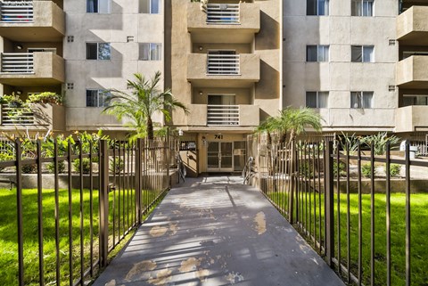 A concrete building with a gate in front of it.