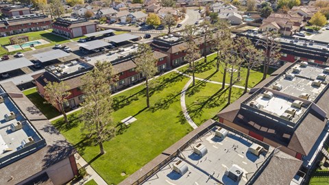 A bird's eye view of a residential area with houses and trees.