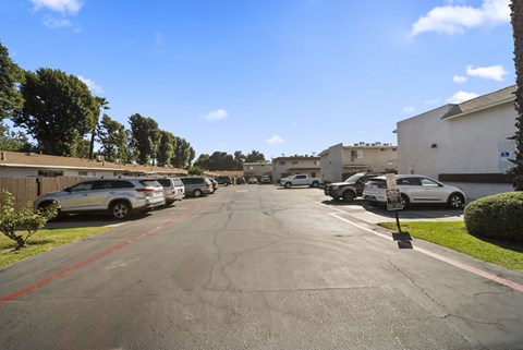 A street with cars parked on both sides and a red line down the middle.