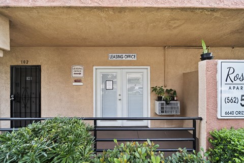 A building with a leasing office sign on the wall.