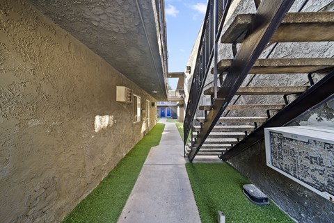A stone wall with a staircase on the right side.