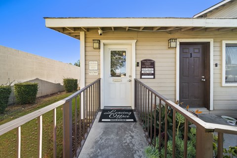 A house with a white door and a sign that says "Loving Wife".
