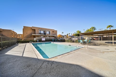A swimming pool in front of a modern building.