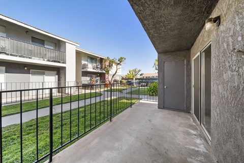 A concrete building with a black fence in front.