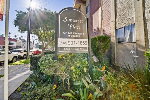 A sign for Somerset Place Apartment Homes is in front of a building.