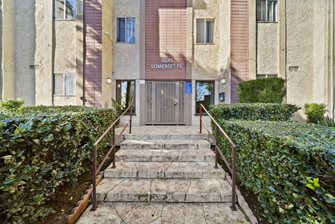 The image shows a building entrance with a sign that reads "6645 SOMERSET PL".
