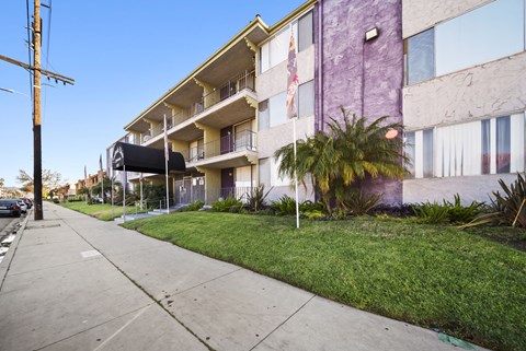 A purple building with a flag on the balcony.