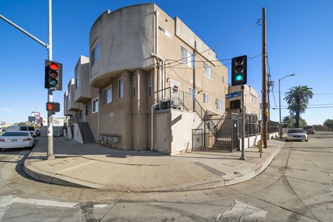 A street corner with a traffic light and a building.