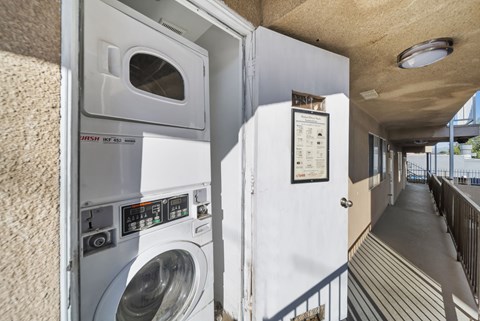 A washing machine is installed in a small room.