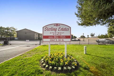 A Sterling Estates Apartments sign is in front of a building.
