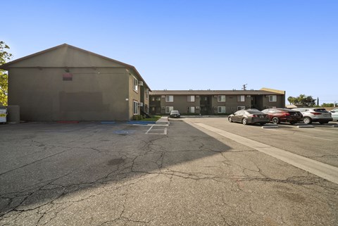 A parking lot with a building in the background.