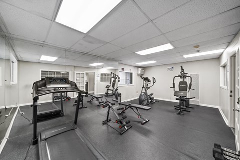 A spacious gym with treadmills, elliptical machines, and other exercise equipment.