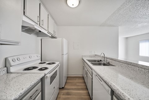 A kitchen with white appliances and cabinets.