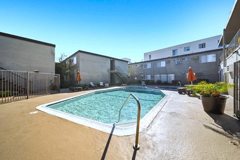 A small pool with a metal fence around it.