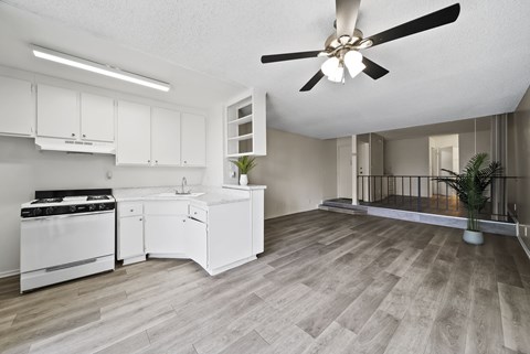 A modern kitchen with a white stove and cabinets.