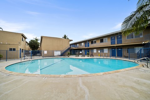 A large outdoor swimming pool surrounded by a fence.