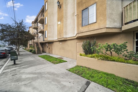 A building with a green lawn in front.