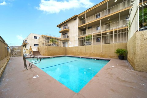A swimming pool in front of a building.