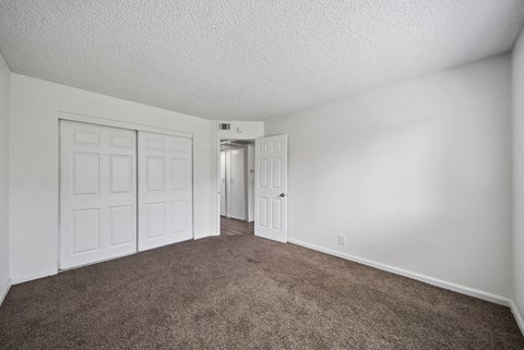 A room with carpeted floor and white walls.