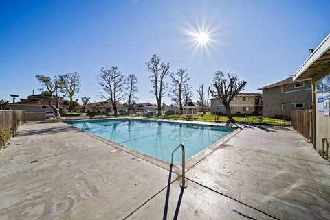 A sunny day at a pool with a clear blue sky.