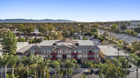 A residential area with apartment buildings and palm trees.