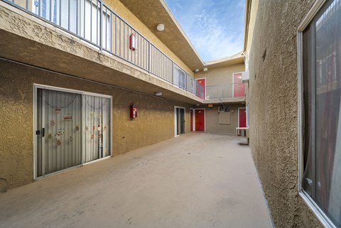 A long hallway with a fire extinguisher on the wall.